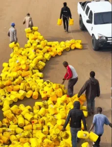 Comedian and activist Eric Omondi pulls empty jerricans on road in fuel price protest