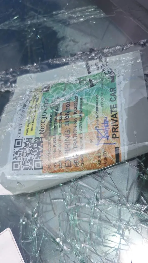 The insurance certificate of vehicle registration number KCQ 222X, visible amid shattered glass at the crash scene along Ngong Road, Nairobi, on April 25, 2026.